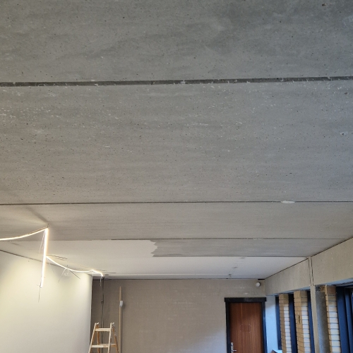 Handyman udfører nedslibning af loft som del af renovering på Vestfyn